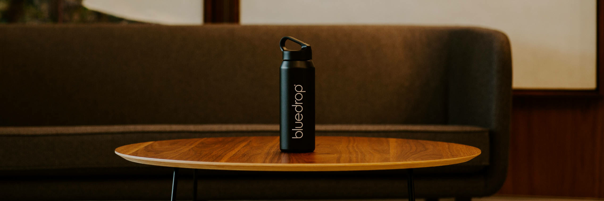 A bluedrop water branded bottle on a table.