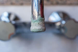 Hard water deposits on a tap.
