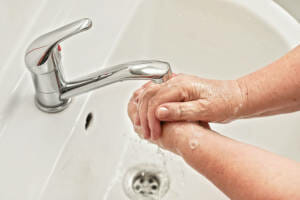 A person washing their hands.