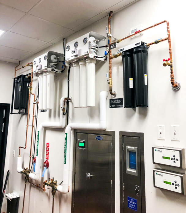 A food service filtration system mounted on a wall.