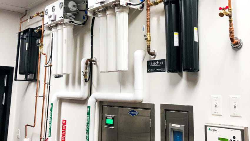 A food service filtration system mounted on a wall.