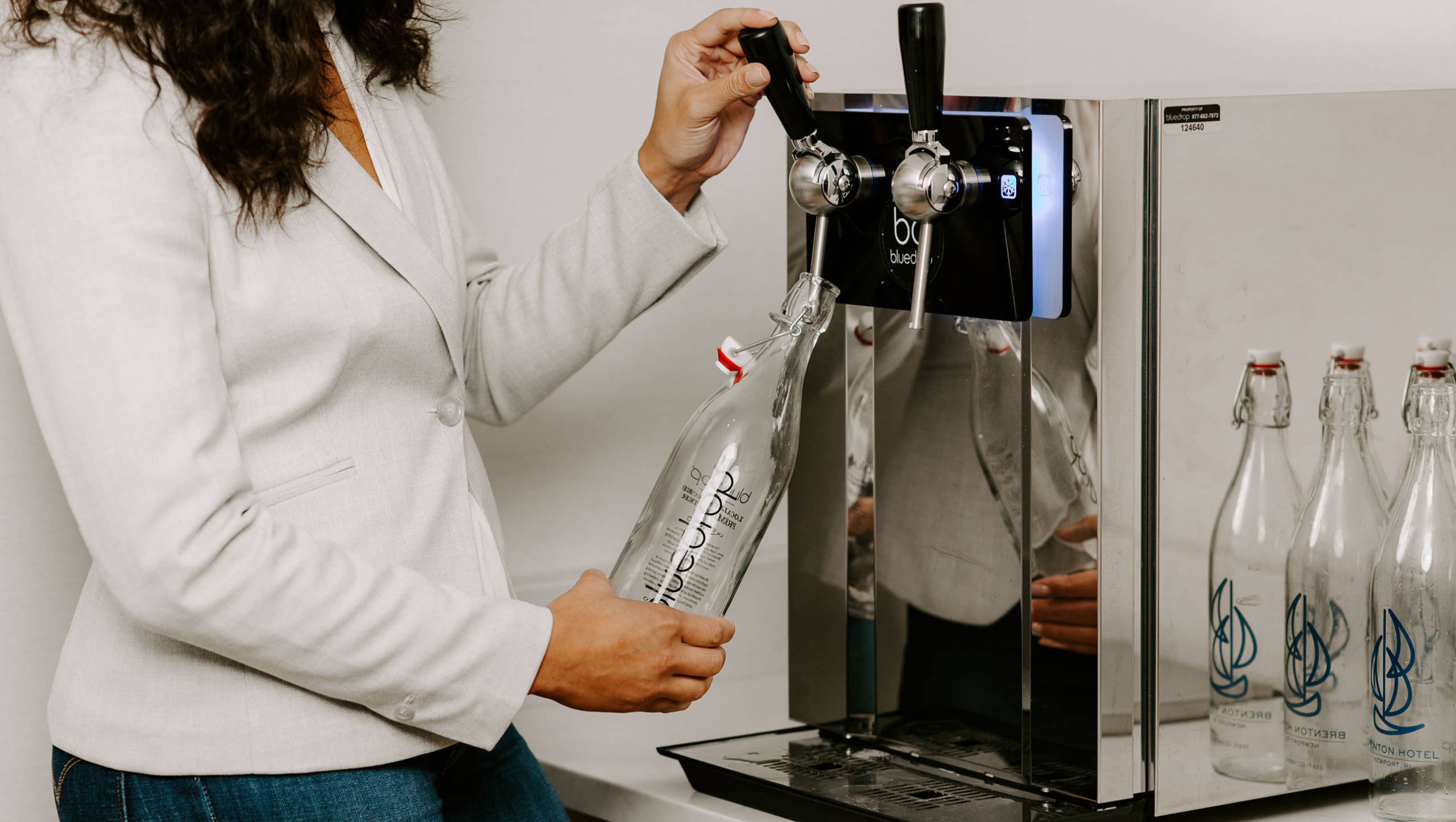 A person filling their water bottle with the Bluedrop product.