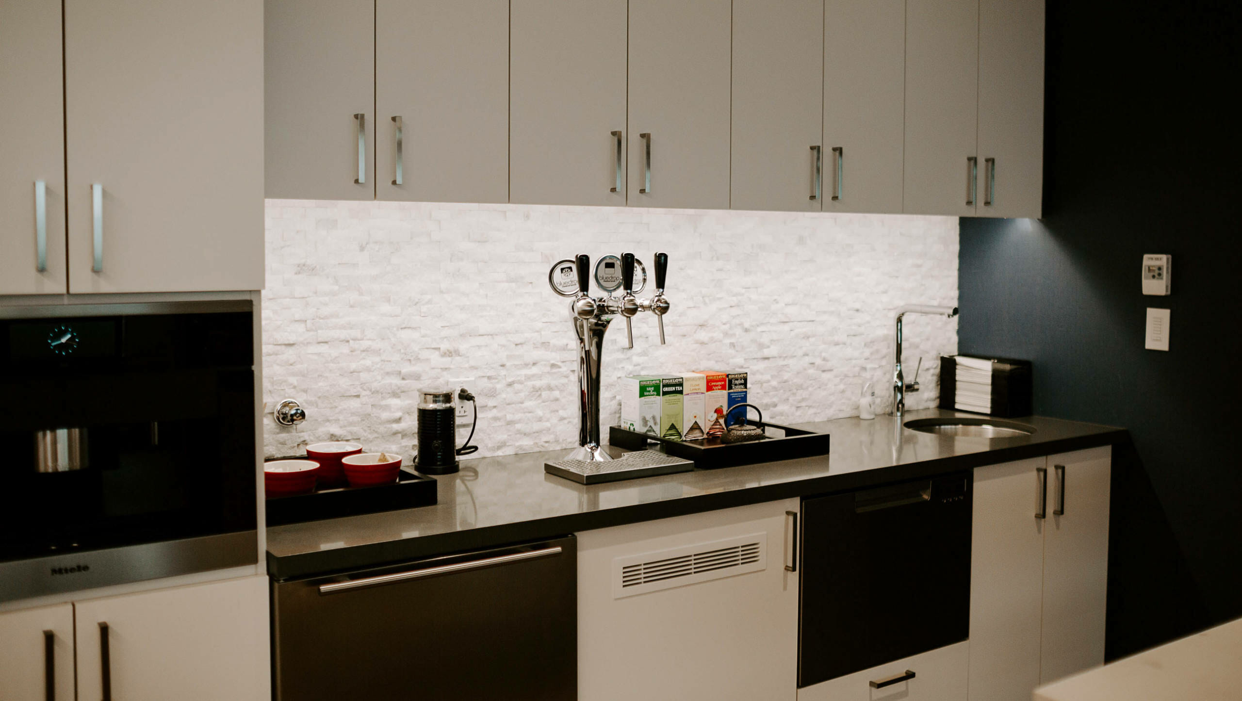 A tower mounted to an office kitchen to allow employees to get water.