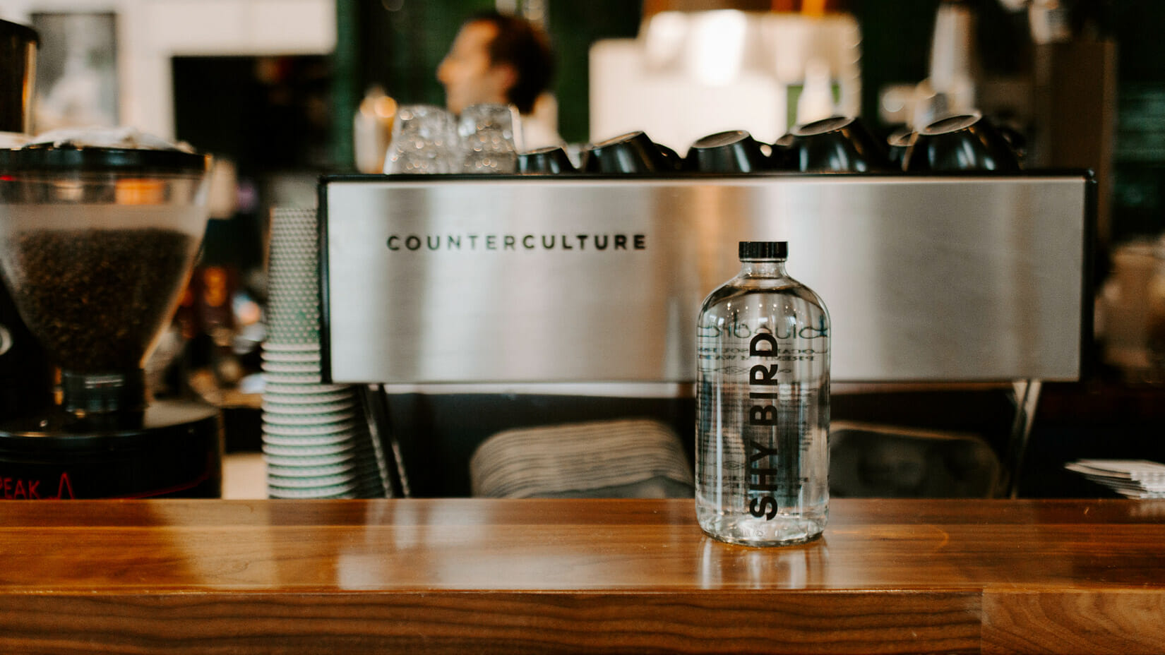 A custom branded bottle on a counter at a restaurant.