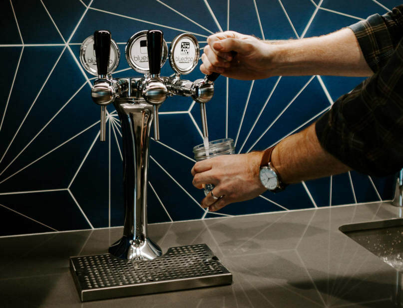 The tower 3 product being used to fill up a glass of water.