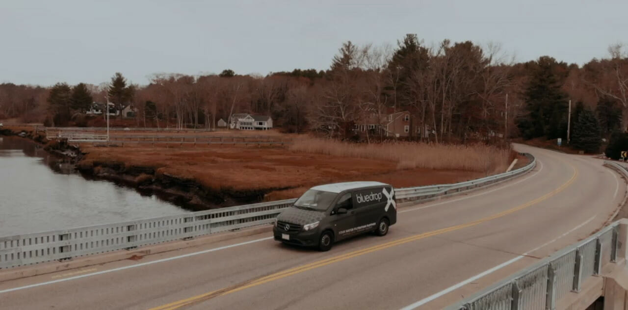 Service video background image of a car driving down a road.