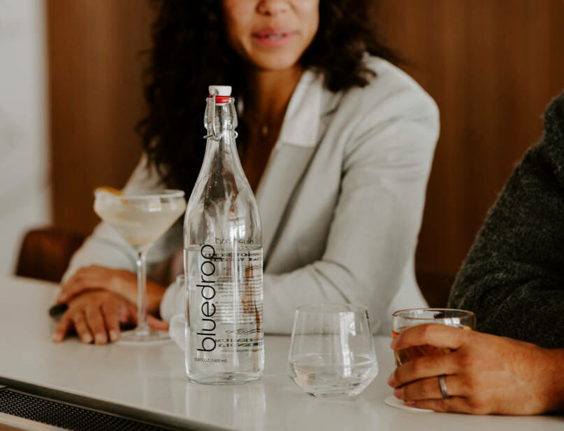 A bottle of bluedrop water on a bar table.