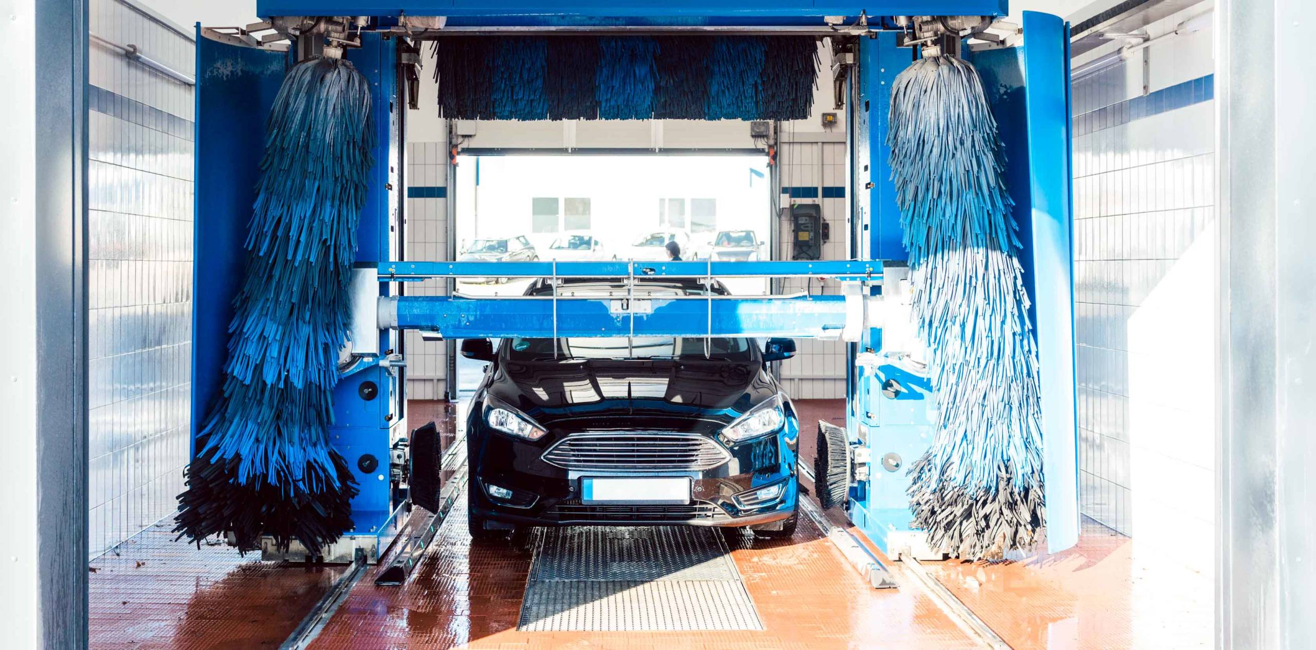 Car going through a car wash illustrating the benefits of softer water on automobiles.