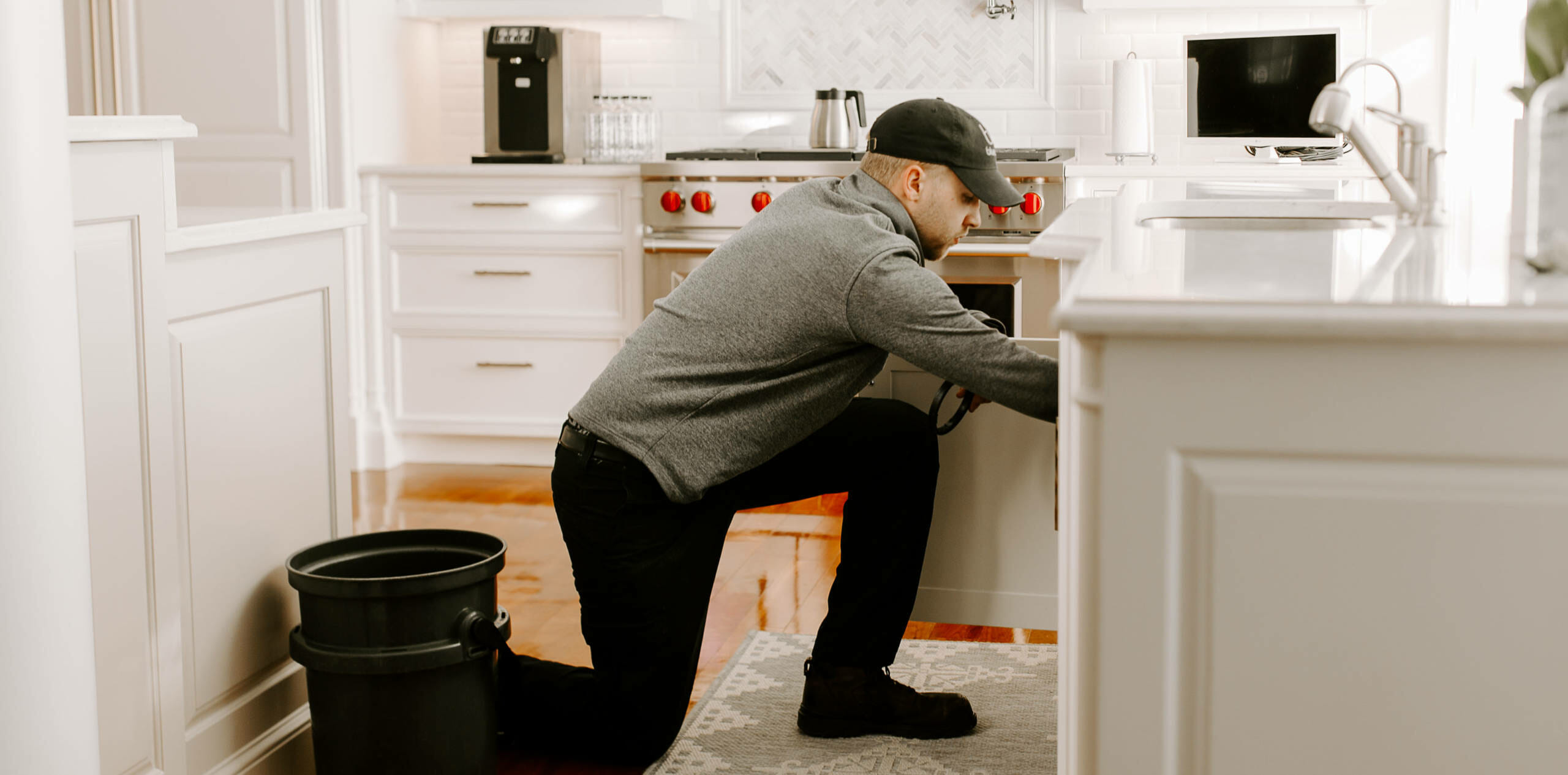 A person adjusting the bluedrop water filtration system.