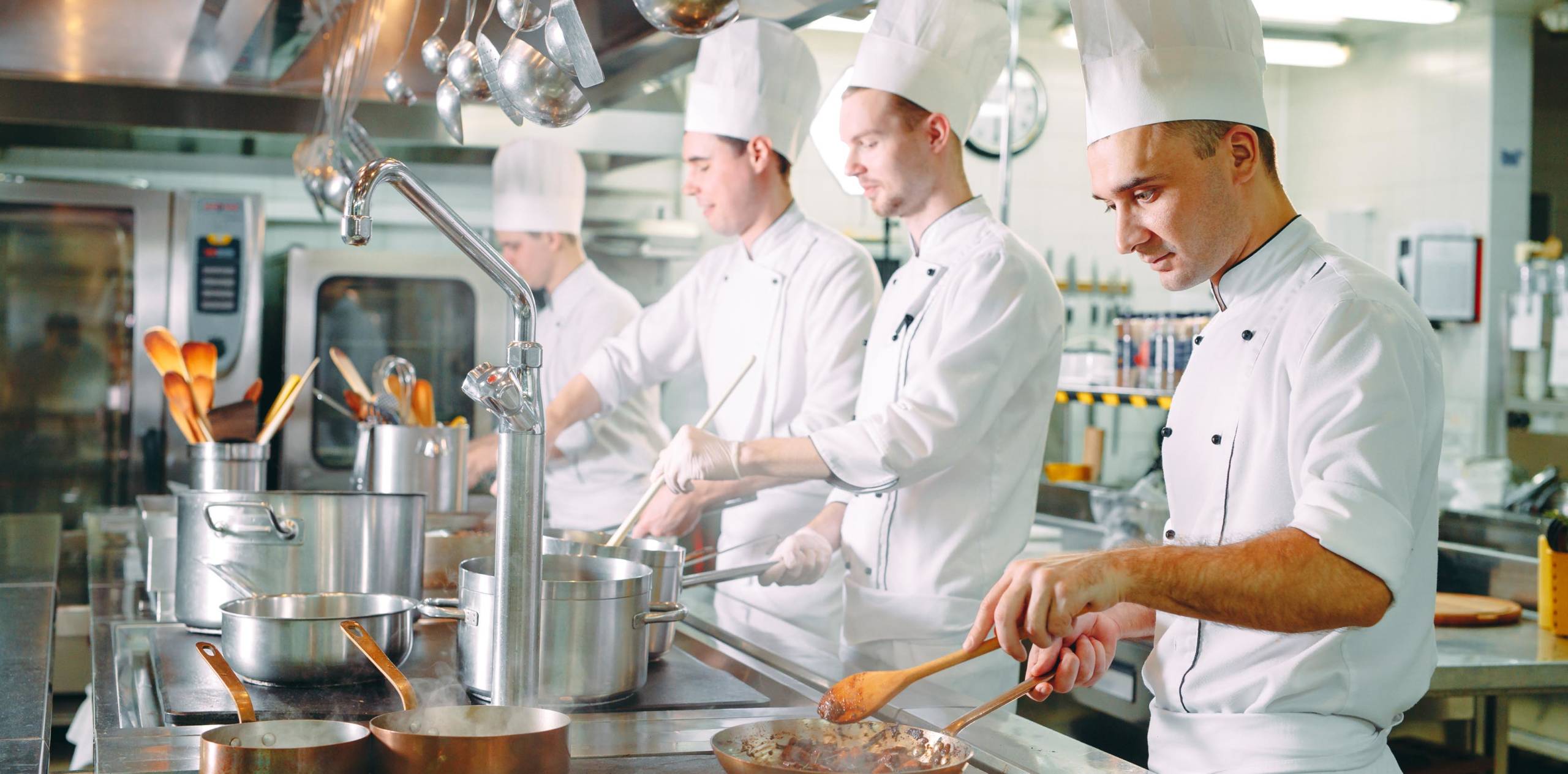 Cooks in a restaurant preparing food.