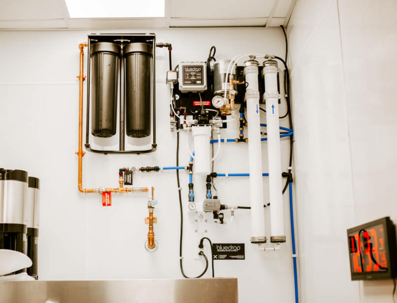 A food service filtration system mounted on a wall.