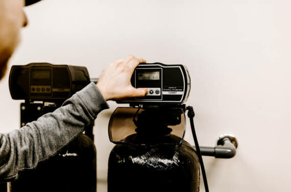 A person adjusting their bluedrop water filtration system.