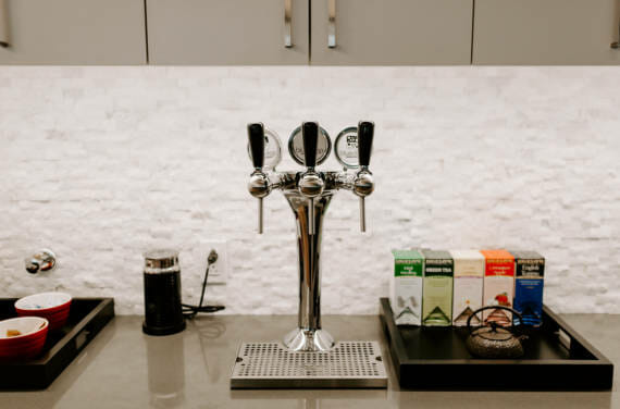 A tower mounted to an office kitchen to allow employees to get water.