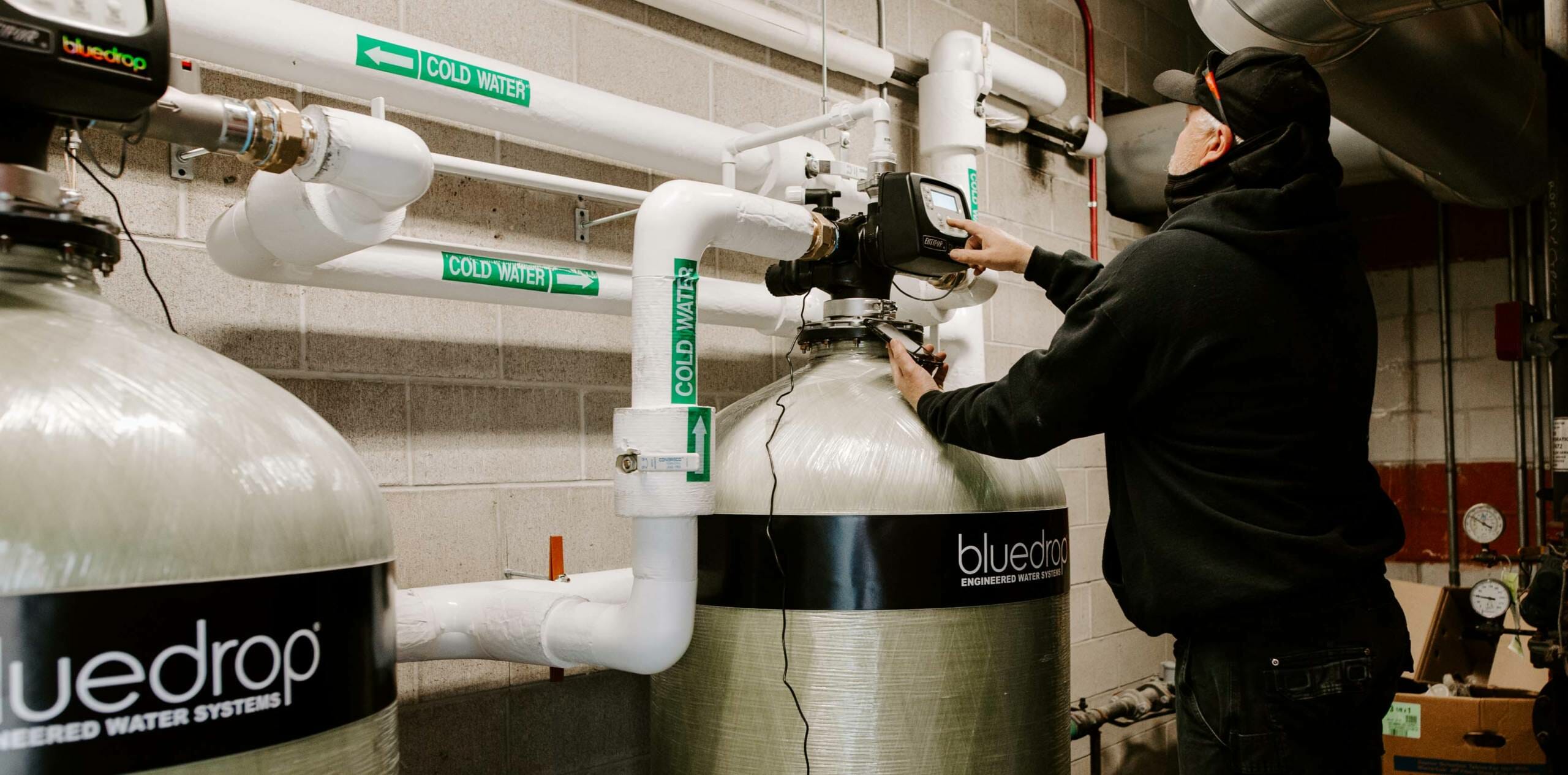 A person adjusting a filtration system.