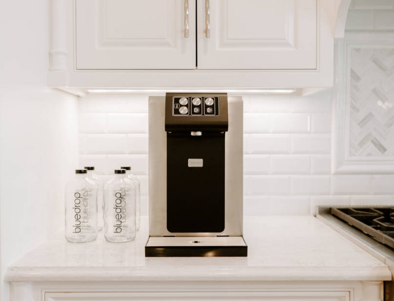 A home still and sparkling water system on a kitchen counter.