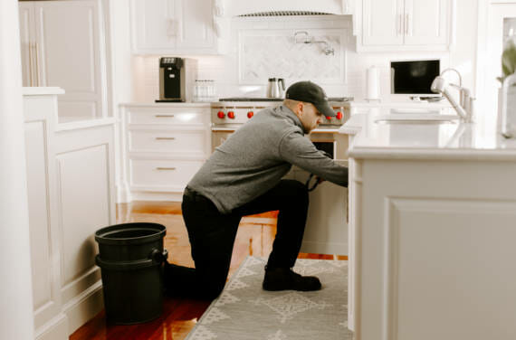 A person adjusting a water filtration system.