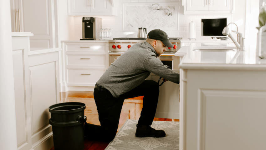 A person adjusting a water filtration system.