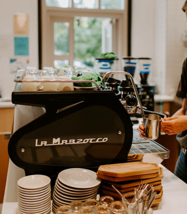 A barista making a coffee using specialty equipment.