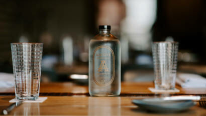 A bottle sitting on a restaurant table at Alcove in Boston.