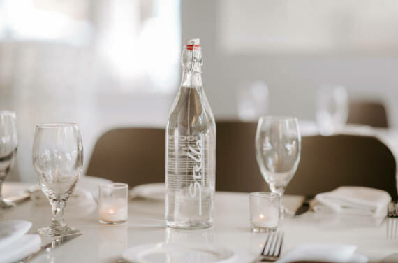 A custom branded bottle sitting on a restaurant table at Stella.