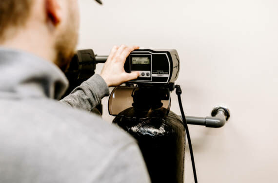 A person adjusting a filtration system.